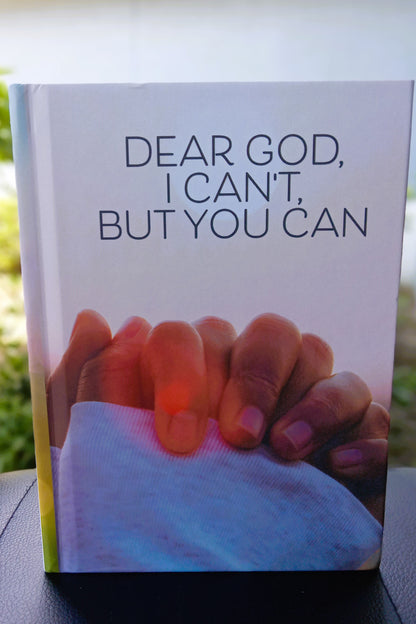 A journal titled "Dear God I Can't, But You Can," showing a woman with her hands in prayer.